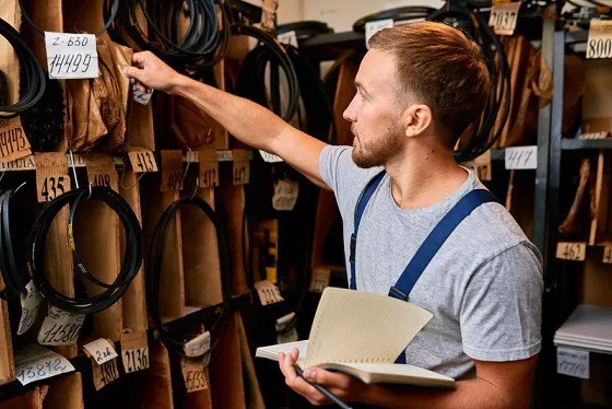 A Storeman reaching for a Part in a Bin in a Warehouse
